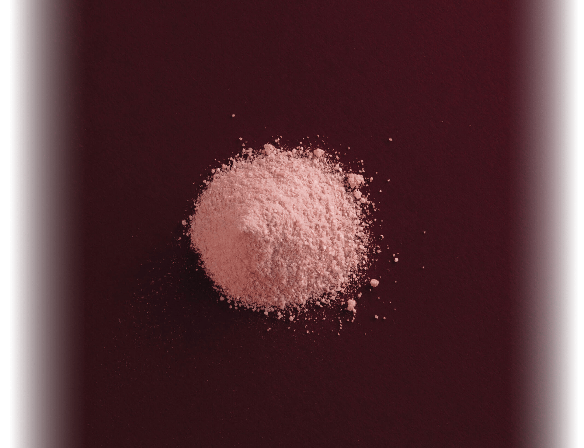 closeup of pink powder on red background