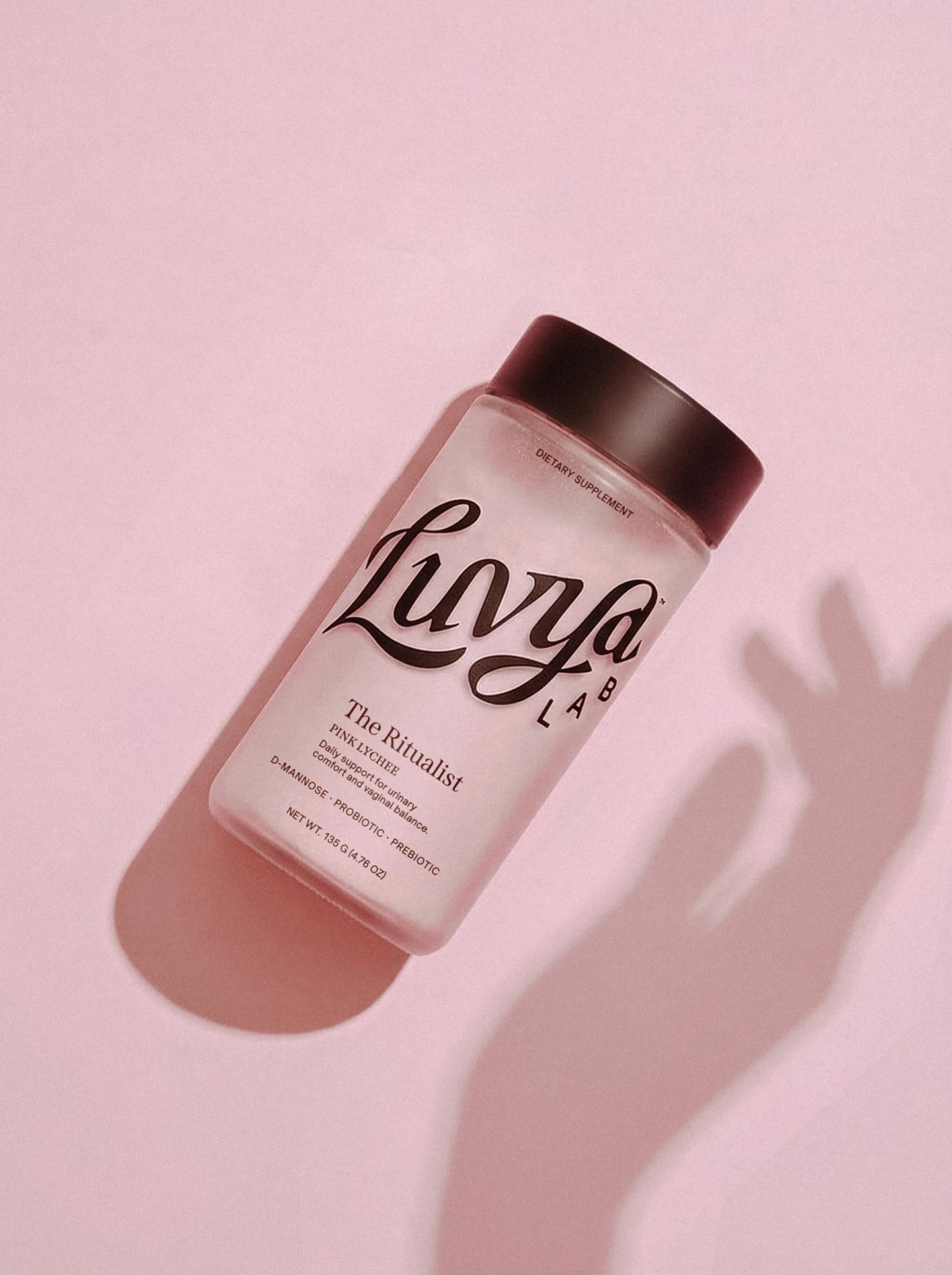 The Ritualist Pink Lychee jar on a blush pink backdrop