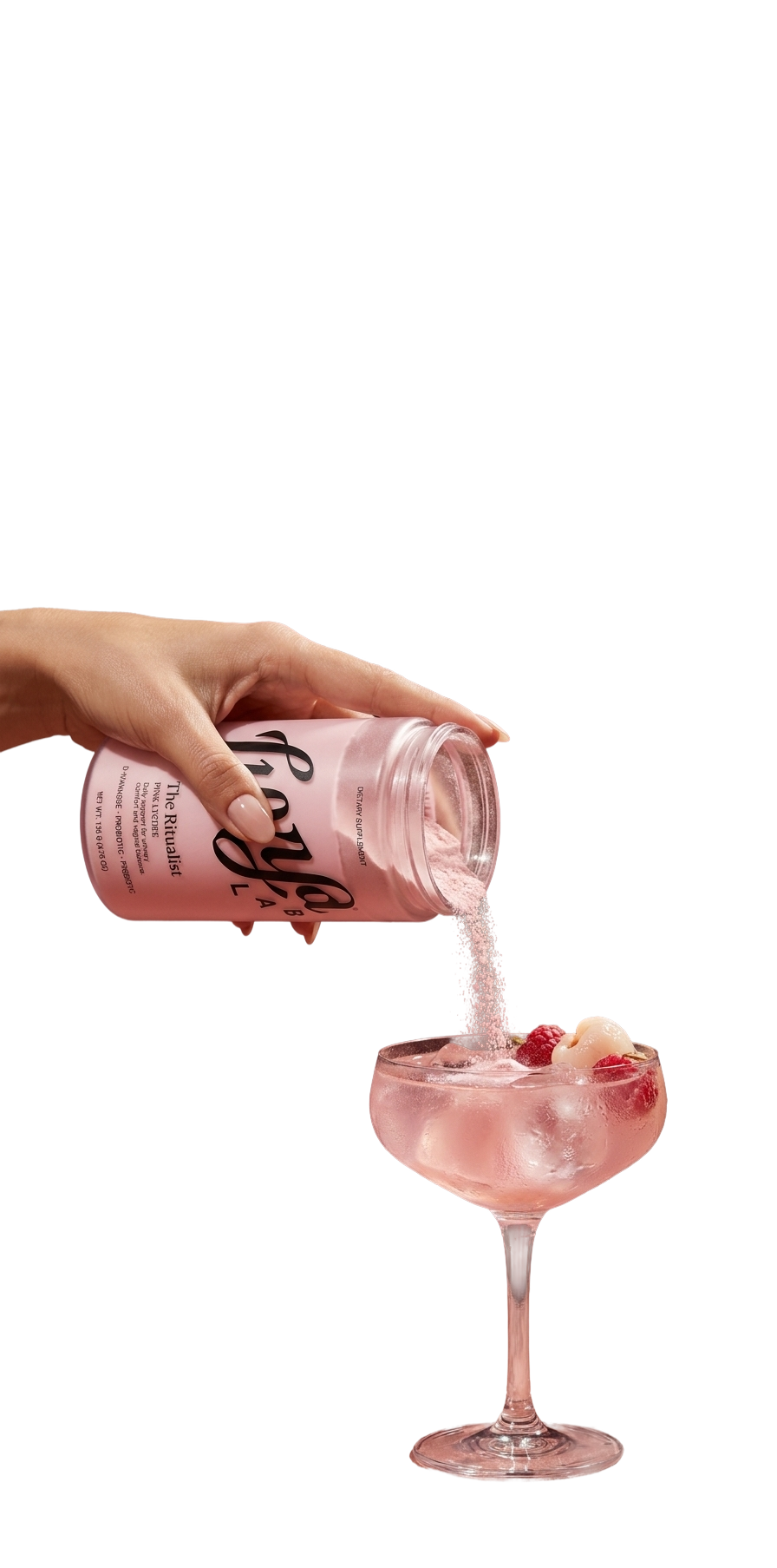 A hand pouring Luvya Lab The Ritualist pink lychee powder from its canister into a coupe glass of iced drink garnished with lychee and raspberries